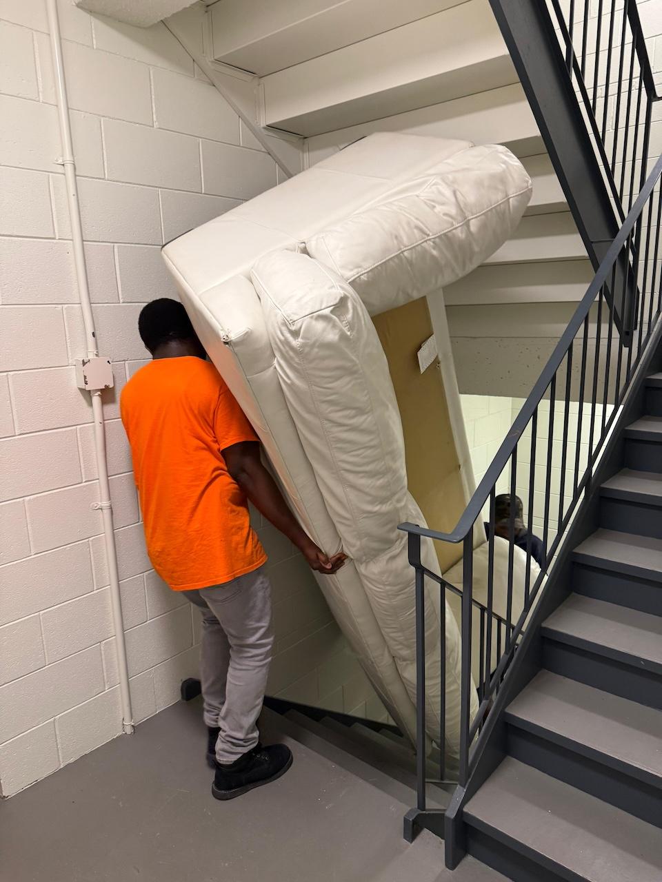 Furniture fully wrapped in protective padding and shrink wrap