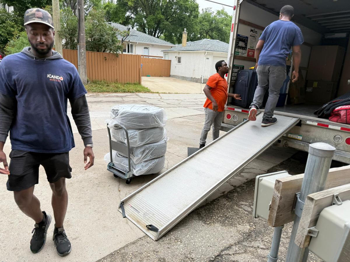 Icando crew loading the truck with the ramp down